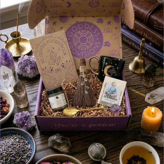 April subscription women box featuring crystal ritual set with tea, notebook, spoon, facial steam, broom, and amethyst crystal