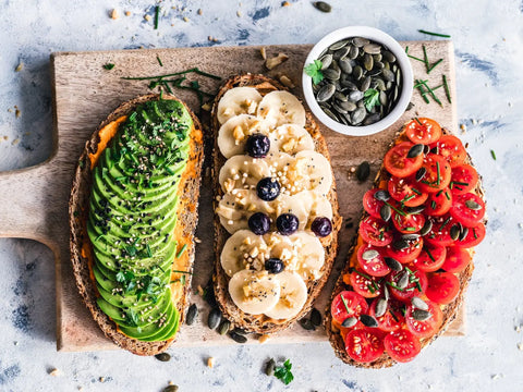 Three slices of gourmet toast with colorful toppings for a relaxing evening snack
