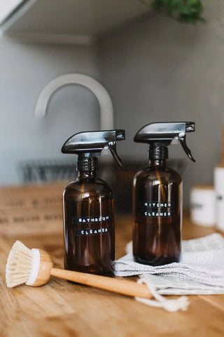 Amber glass spray bottles with black nozzles for aura cleansing and bathing rituals