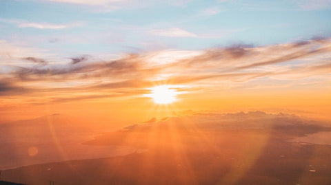 Vibrant sunset over a misty landscape illustrating Lessons from The Sun article