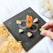 Infinite Magic Altar with a hand placing crystals on tile. Altar tools available at Goddess Provisions.