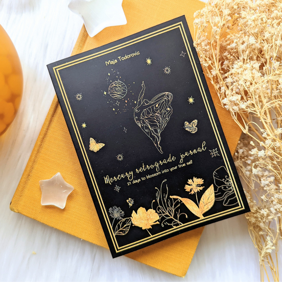 Mercury in Retrograde Journal front on another book