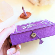 Stupa Smoke Rope Incense and womans hand holding the box. Available at Goddess Provisions
