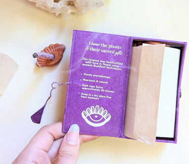 Stupa Smoke Rope Incense with product description inside box and woman's hand holding the box open