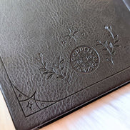 Mystical Musings Divination Diary showing a clear quartz crystal design surrounded by moon phases, ideal for amplifying dreams and manifestations.