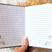 A5 celestial journal made from recycled paper, with 120 lined pages and embossed moon phases design on black vegan leather. Perfect for magical moments and daily to-dos.