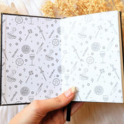 A5 celestial journal made from recycled paper, with 120 lined pages and embossed moon phases design on black vegan leather. Perfect for magical moments and daily to-dos.