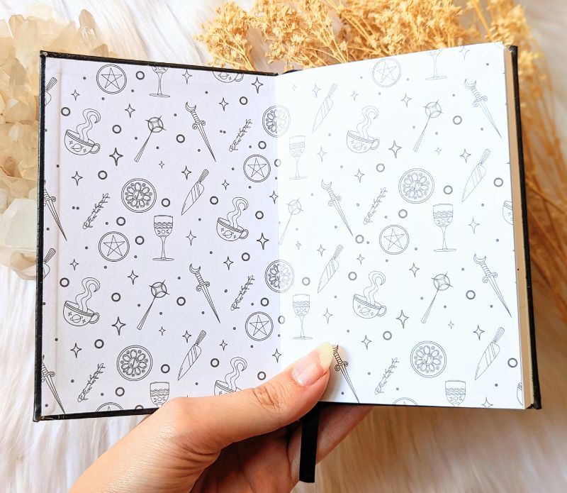 A5 celestial journal made from recycled paper, with 120 lined pages and embossed moon phases design on black vegan leather. Perfect for magical moments and daily to-dos.