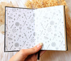 A5 celestial journal made from recycled paper, with 120 lined pages and embossed moon phases design on black vegan leather. Perfect for magical moments and daily to-dos.