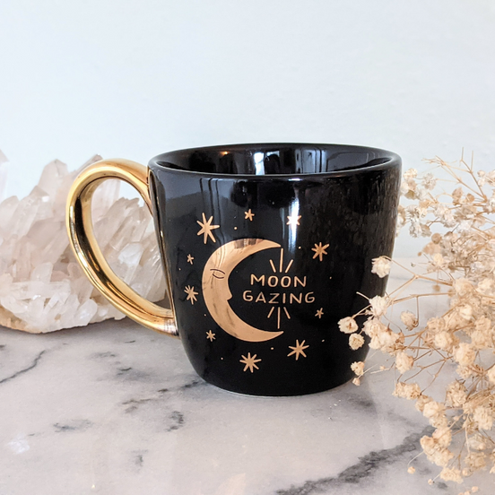 Black and celestial ceramic mug with moon and sun design available at Goddess Provisions