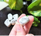 Experience tranquility with the tumbled White Howlite. This soothing crystal supports emotional balance, patience, and spiritual growth, perfect for meditation and healing rituals. Available at Goddess Provisions.